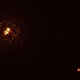 The b Centauri system, with the newly discovered exoplanet shown at bottom right and the star pair at left. (Top right dot is an unrelated background star.) The rings that appear around the star pair are optical noise.